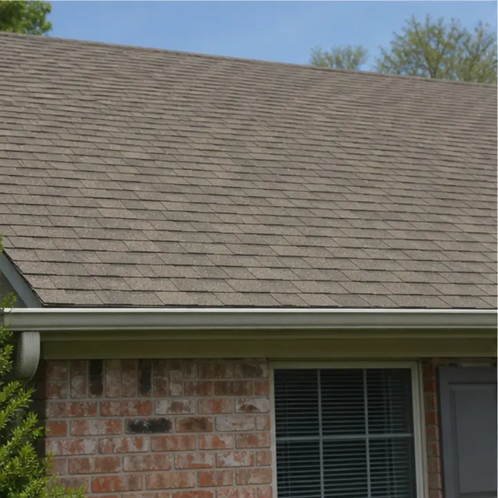 Asphalt shingle roof edges sitting flat near a chimney.